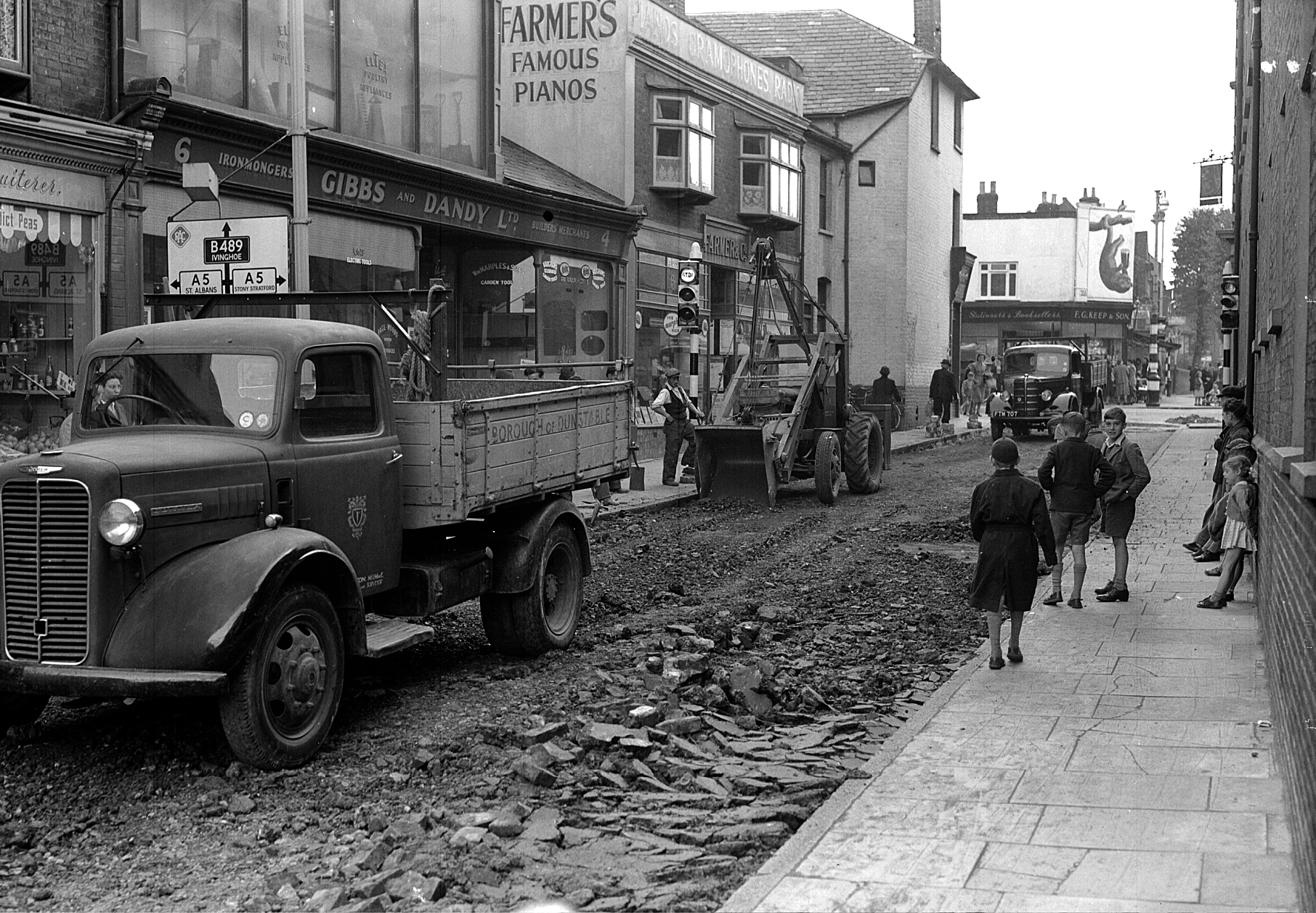 Farmer's music shop and Gibbs and Dandy are seen in the background of this photo of Church Street being resurfaced in 1952.